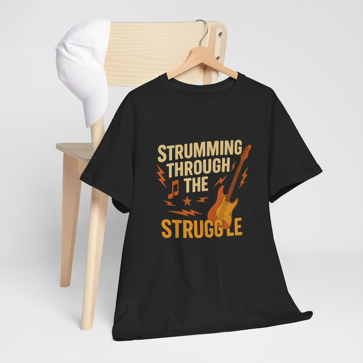 Strumming Through the Struggle, Comfortable, Unisex, Cotton Tee - Rock Music Lover's Motivational T-Shirt