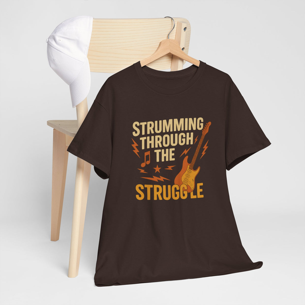 Strumming Through the Struggle, Comfortable, Unisex, Cotton Tee - Rock Music Lover's Motivational T-Shirt